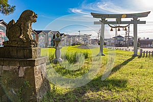 At sundown, komainu and torii gate at the site of the annual Okaeri Welcome Home festival, Mikawa, Japan.