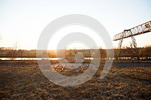 Sundowner at a lost place with crane and railways in fresenburg emsland germany photo