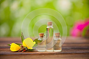 Sundrops essential oil in beautiful bottle on wooden background photo