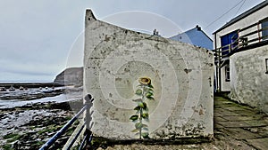 Sunflower artwork on an old seaside building