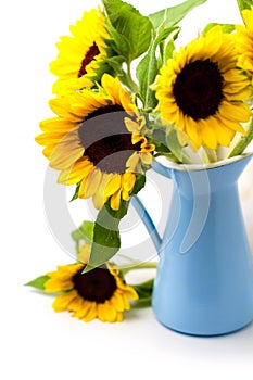 Sunflower bouquet in blue enamel jug photo