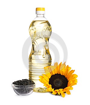 Sunflower cooking oil, seeds and yellow flower on white background