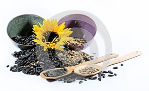 Sunflower, cups, wooden spoons and sunflower seeds