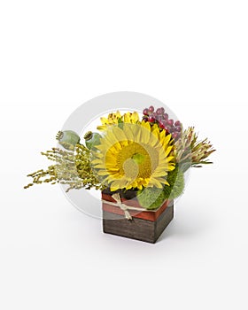 Sunflower and mixed flower arrangement. Modern floral design in a rustic box for florist.