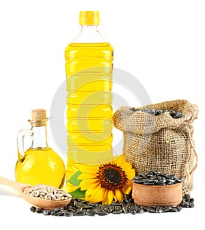 Sunflower oil in plastic bottle, seeds and flower isolated on white background