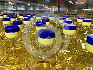 Sunflower oil in plastic bottles with bright caps. A lot of bottles with clear vegetable oil. Business in sunflower oil, sale