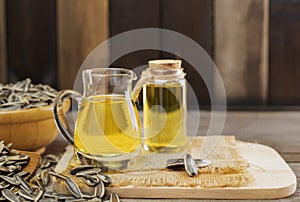 Sunflower oil and sunflower seeds On a traditional rustic wooden floor Concept of organic food and environment Healthy food and