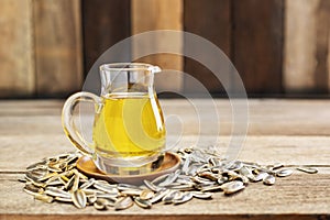 Sunflower oil and sunflower seeds On a traditional rustic wooden floor Concept of organic food and environment Healthy food and