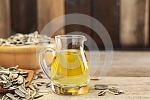 Sunflower oil and sunflower seeds On a traditional rustic wooden floor Concept of organic food and environment Healthy food and