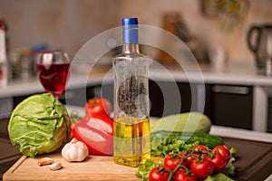 Sunflower oil on the table near fresh vegetables