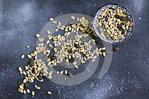 Sunflower and pumpkin seeds in bowl on the blue background. Large group of seeds