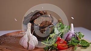 Sunflower seeds falling on a plate with bread crackers and vegetables 1