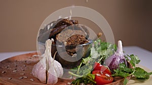 Sunflower seeds falling on a plate with bread crackers and vegetables 2