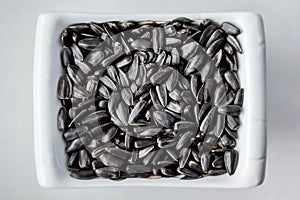 Sunflower seeds lying in a plate can serve as a background_