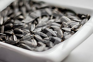 Sunflower seeds lying in a plate can serve as a background_