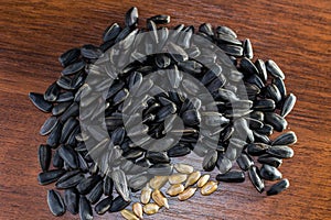 Sunflower seeds lying on the wood table. Blurred background.