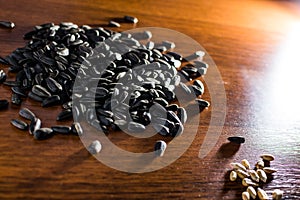 Sunflower seeds lying on the wood table. Blurred background.