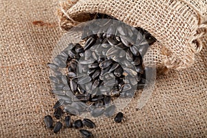 Sunflower seeds in a sack on burlap.