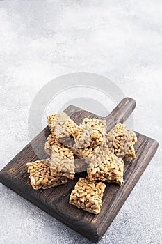 Sunflower seeds in sugar glazed, oriental sweetness of brittle. Kozinaks are broken into pieces on a wooden Board, copy space