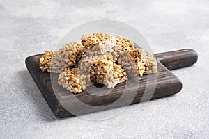 Sunflower seeds in sugar glazed, oriental sweetness of brittle. Kozinaks are broken into pieces on a wooden Board, copy space