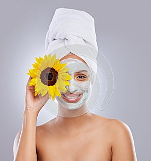 Sunflower, woman and face mask for skincare, cosmetic and facial treatment on white background. Beauty, natural or