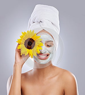 Sunflower, woman and face mask for skincare, cosmetic and facial treatment on white background. Beauty, natural or