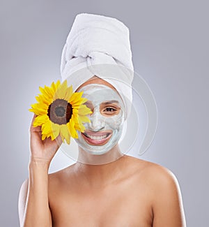 Sunflower, woman and face mask for skincare, cosmetic and facial treatment on white background. Beauty, natural or