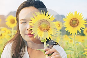 Sunflower and a woman hiding behind it