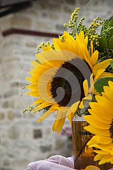 Sunflowers bouquet against a brick wall