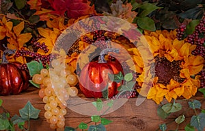 Sunflowers, grapes, and pumpkins fill a decorated Thanksgiving mantel