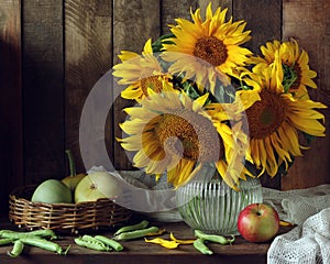 Sunflowers in the jar on the table in country interior.
