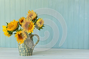 Sunflowers. Summer bouquet in crockery with pastel background