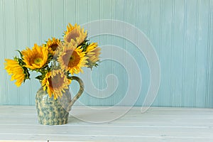 Sunflowers. Summer bouquet in crockery with pastel background