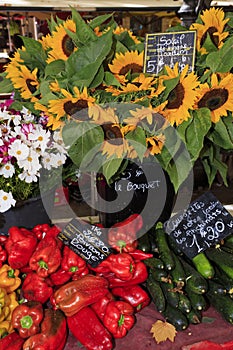 Sunflowers and vegetables for sale at a market in Provence