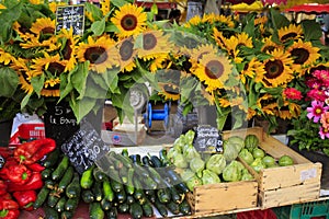 Sunflowers and vegetables for sale at a market in Provence