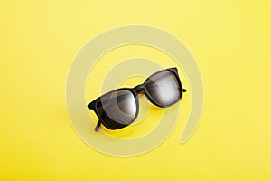 Sunglasses with black lenses, plastic spectacle frame.