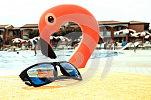 Sunglasses closeup summer background. Beach pool equipment with travel sunglasses on yellow holiday towel. Outdoor relax