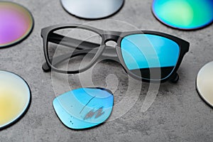 Sunglasses with damaged colored lens on table