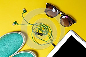 Sunglasses, earphones, shoes and a phone