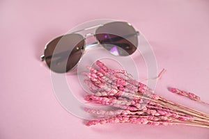 Sunglasses with flower on the table