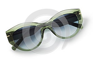 Sunglasses in green bright color in transparent plastic. Eyewear top view with shadow. Trendy glasses isolated on white background