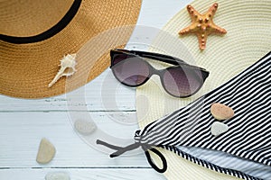 Sunglasses, hat and swimsuit on a white background. Vacation on the beach
