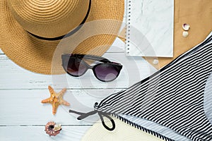 Sunglasses, hat and swimsuit on a white background. Vacation on the beach.