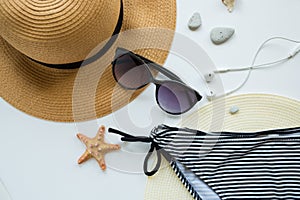 Sunglasses, hat and swimsuit on a white background. Vacation on the beach.