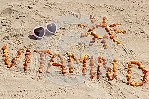 Sunglasses, inscription vitamin D and shape of sun at beach, concept of summer time and healthy lifestyle