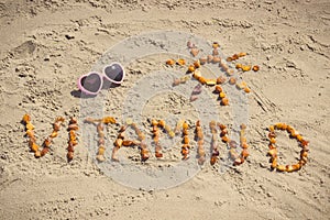 Sunglasses, inscription vitamin D and shape of sun on sand at beach, summer time and healthy lifestyle