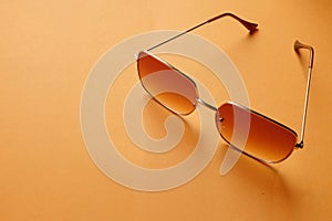 Flat lay  Square sunglasses isolate on a orange background