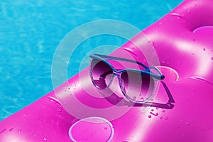 Sunglasses pink air mattress swimming pool. Tropical concept