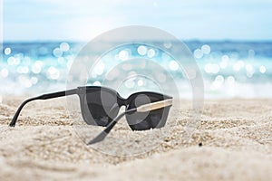 Sunglasses placed on the sandy baeach
