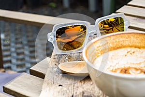 Sunglasses refection of coffee cup